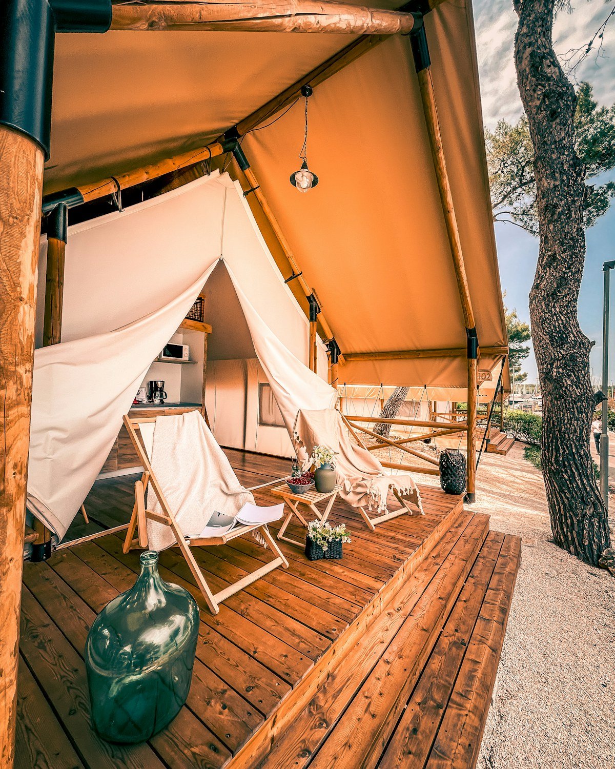 Luxury safari glamping tent with a furnished wooden deck